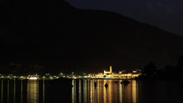 Italian village Feriolo at Lago Maggiore at night with boats time lapse