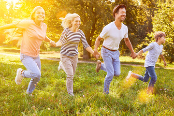Fototapeta na wymiar Happy family with children exercising in the garden