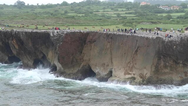 waves breaking on cliffs of jesters of pria