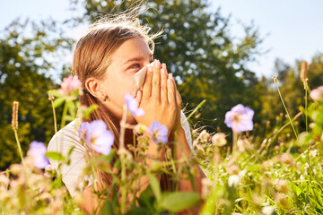Girl with hay fever blows her nose