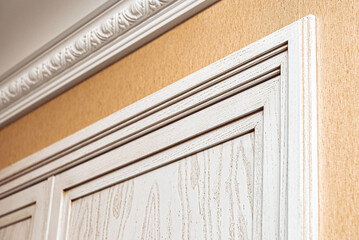 Fragment of built-in wardrobe made of veneer and solid ash in light enamel with gray patina....