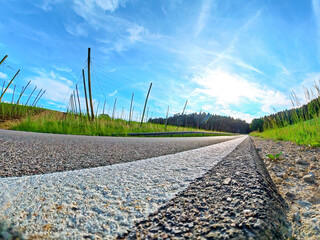 Bavarian Asphalt Road to Sunlight with green environment 
