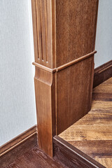 Lower part of wooden carved doorway with with steps made of toned solid oak and oak veneer close...