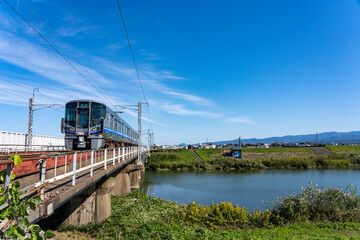 加賀平野を流れる梯川を渡る北陸本線の列車