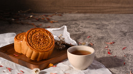 Mid autumn festival mooncake and and green tea on stone table