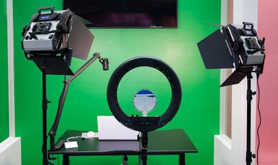 Equipment for personal broadcasting with green background and lights.