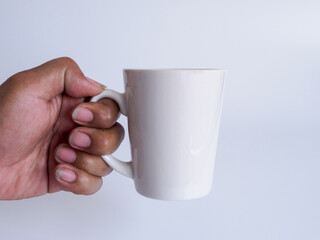Man hand holding a white coffee cup, filled with hot black coffee(americano), no sugar no milk,...