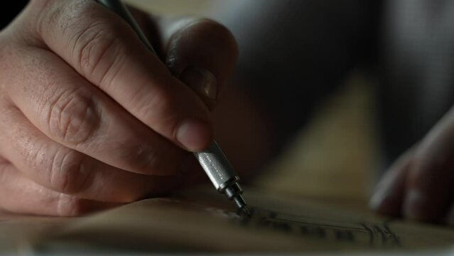 Man's hand is drowing on the old paper. Pen Writes On Paper In Blue Ink. Close. Someone Writes Very Fast. 4k shot