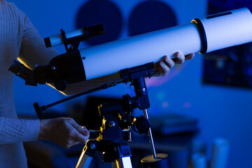 Astronomer man setting telescope at the night sky, space, cosmos, universe, Milky way. Male scientist adjusting telescope to stars and Moon with professional telescope at summer day. Do astronomy work © Monstar Studio
