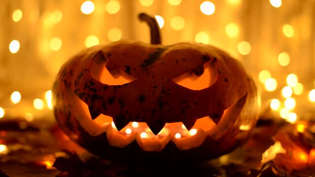 Halloween pumpkin with bright background of garlands. Halloween concept