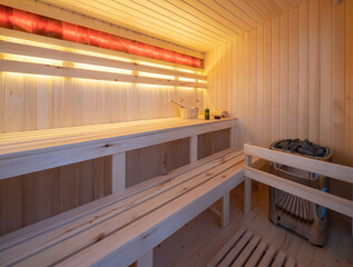 Interior of wooden finnish sauna. Luxury private house.