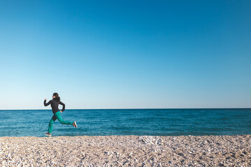 A girl on a morning jog on the beach
