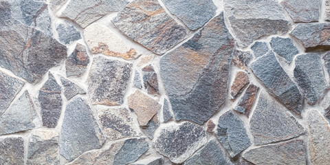 Gray stone texture. Brick wall background. Abstract rocks pattern. Grey stones, textured surface. Natural backdrop. Mosaic of bricks. Grunge surface. Template with copy space.