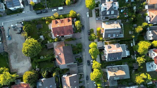 Birdseye aerial view suburban munich. drone flying top down over middle class family houses with small garden in europe. Edge of city residential area popular for young families.