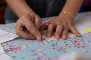 Latin American seamstress inserts sewing pins