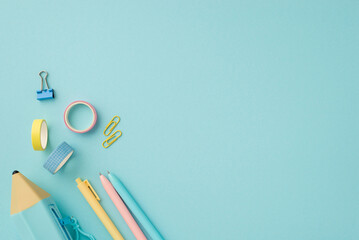 Back to school concept. Top view photo of school supplies colorful pens blue pencil-case adhesive tape and binder clips on isolated pastel blue background with copyspace
