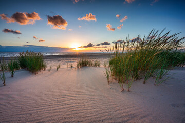 Beautiful sunset on the beach of the Sobieszewo Island at the Baltic Sea. Poland - obrazy, fototapety, plakaty