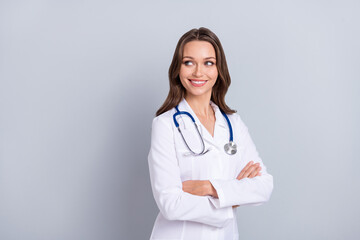 Photo of smiling lady virologist look empty space cross arms recommend cov vaccine prevention isolated grey color background