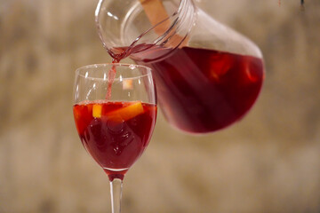 sangria. sangria while being poured from the carafe into the glass.