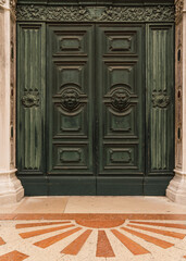 Detail of an old green door of a church with detail in Venice, Italy 