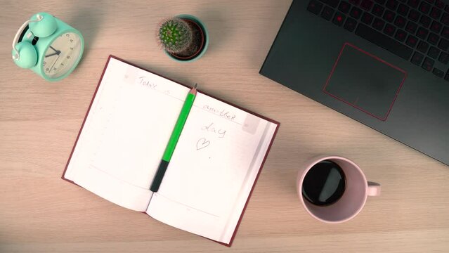 Male hands aranging items on work desk moving laptop and coffee