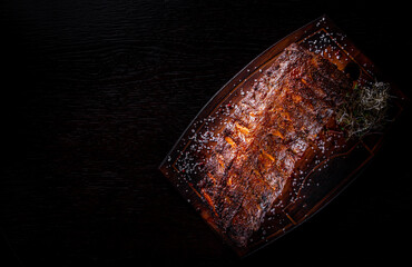 grilled and barbecue ribs pork on dark wooden background