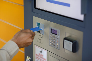 Male customer pays credit card using automated mail terminal or self-service locker. Mail delivery...