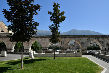 The arches of an ancient Roman aqueduct in the historic district of Sulmona, an Italian village in the Abruzzo region.
