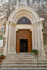 Fototapeta na wymiar The entrance door into a medieval church in Sulmona, an Italian village in the Abruzzo region.