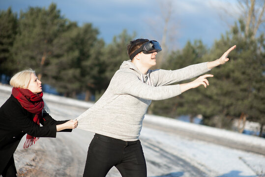 Funny young couple having fun with virtual reality glasses 