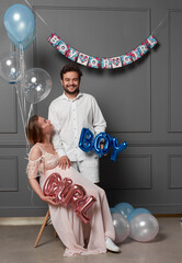 Full length image of a two model they look at each other, holding inscription boy or girl during gender reveals party.