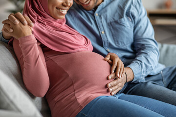 Obraz na płótnie Canvas Happy Pregnancy. Loving Husband Tenderly Touching Belly Of His Pregnant Muslim Wife