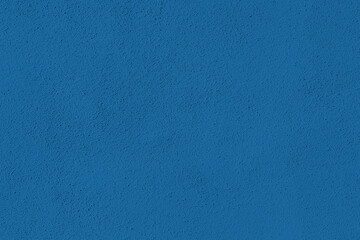 Saturated turquoise blue colored low contrast Concrete textured background. Empty colourful wall...