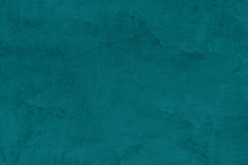 Saturated emerald green colored low contrast Concrete textured background. Empty colourful wall...