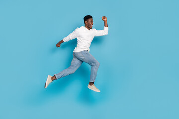 Fototapeta na wymiar Full body portrait of excited person hurry rush look empty space isolated on blue color background