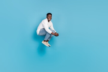 Fototapeta na wymiar Full size photo of satisfied overjoyed person falling have good mood isolated on blue color background