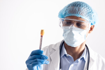 African american male doctor wearing face mask, holding vial with monkeypox virus