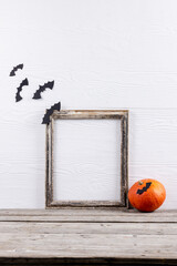 Composition of frame with copy space, halloween decorations and pumpkin on white background