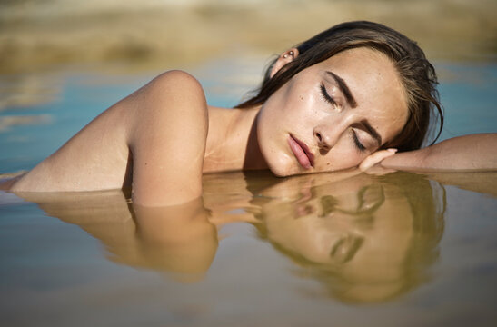 portrait of young woman immersed in the sea water
