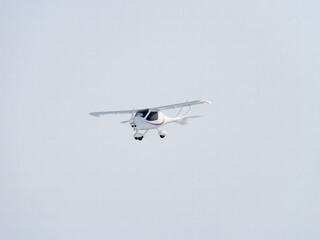 Zoom photo of small propeller airplane landing to small airport