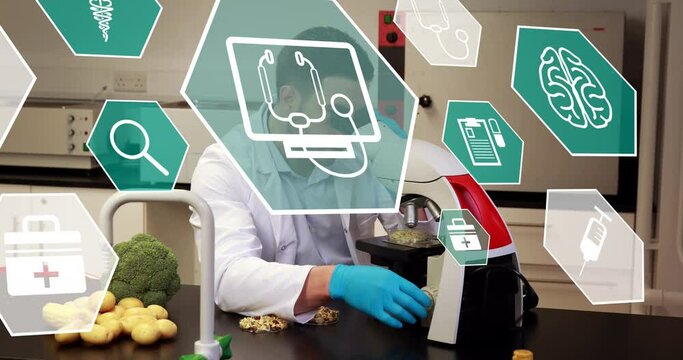 Animation of scientific icons in hexagons over caucasian male lab worker using microscope