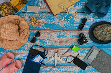 Man and woman pair vacation accessories on the blue wooden boards. Concept: family going on vacation.