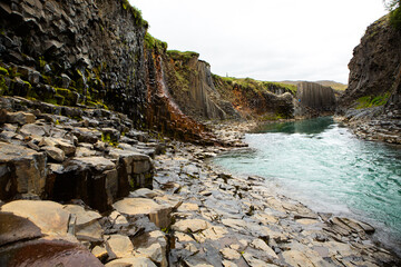 canyon with basalt columns and crystal clear water