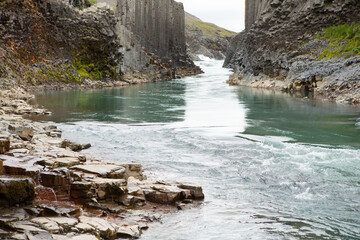 canyon with basalt columns and crystal clear water