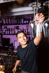 waiter grabbing a clean glass of wine hanging