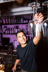 waiter grabbing a clean glass of wine hanging