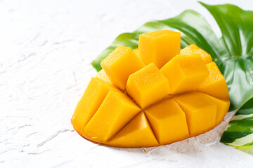 Mango background design concept. Top view Diced fresh mango fruit on white table.