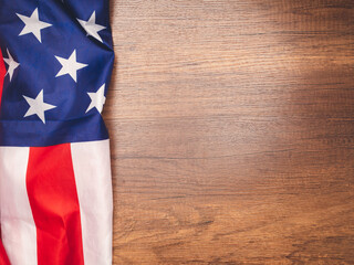 Fototapeta na wymiar Top view of the American flag on a wooden table with copy space for text