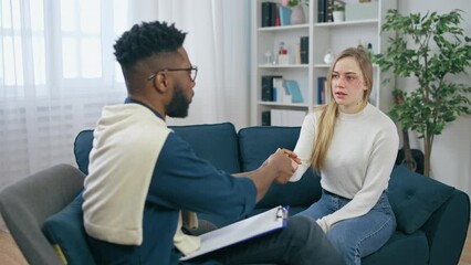 African American psychiatrist shaking hands and saying goodbye with a patient
