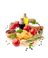Fresh tomatoes with basil leaves, rosemary,  pepper, olive oil, balsamic vinegar and cheese  isolated on white background. Ripe tomatoes with spices.